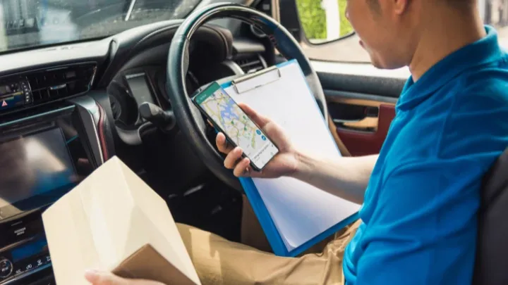 Delivery Driver using the SmartRoutes Mobile App while making a delivery