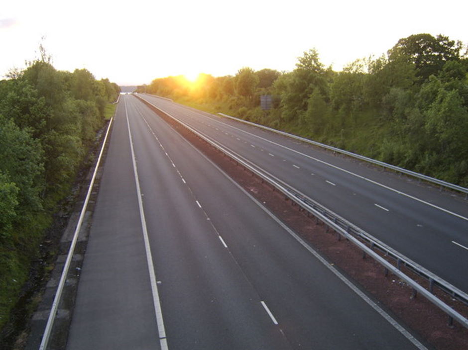 Sun setting over an empty motorway